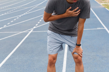Sport man suffering from chest pain heart attack after running. Healthcare and medical concept.