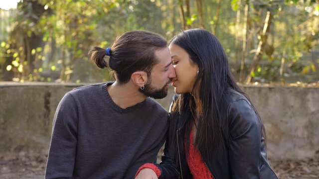 young lovers kissing for first time at the park.Romance,first date, love