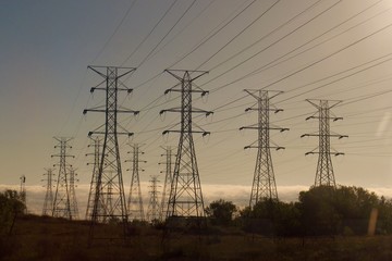 Fototapeta premium power lines and pylons at sunrise