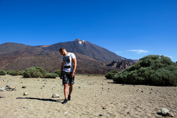 young man by the peak of volcano Teide