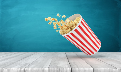 Fototapeta na wymiar 3d rendering of popcorn bucket on wooden surface near blue wall with copy space.