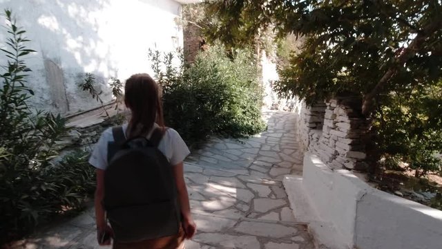 Alone Caucasian Women Walking on Paved Stones. Tinos Island, Greece. Slow Motion.
