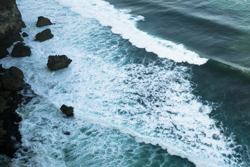 Breaking blue wave in bali, indonesia