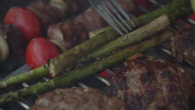 Outdoor grill with beef and vegatables in slow motion. 