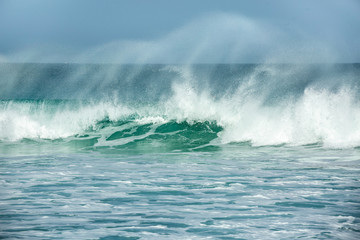 Rolling turquoise surf breaks at Fistral beach in Cornwall