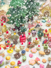 Merry Chrismas with a lot of miniature toys in snow. Sweet party, dessert table toy concept.