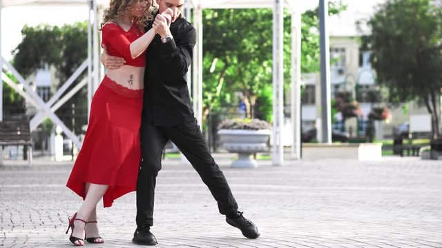 Beautiful couple dancing the street tango