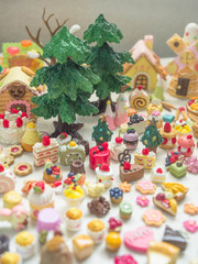Fototapeta na wymiar Merry Chrismas with a lot of miniature toys. Sweet party, dessert table toy concept.