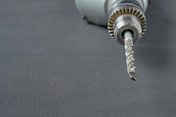 One old dirty scratched used electric drill or perforator with messy auger for repair or other hard...