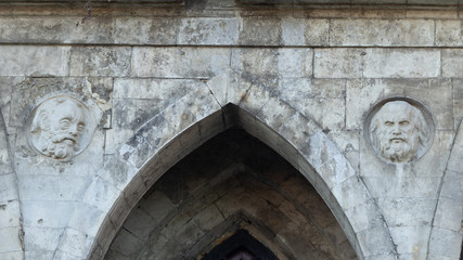 The bas-relief on the wall of white stone. Orthodox church of the 18th century. Pseudo-Gothic style of architecture.