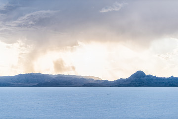 Bonneville Salt Flats and storm clouds near Salt Lake City, Utah and mountain view during sunset with nobody