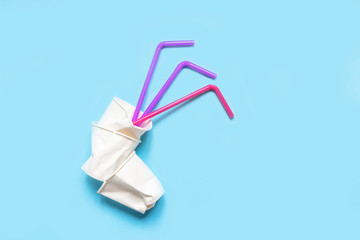 Set of plastic utensils glasses, forks, spoons on a blue background, flat lay. Concept collection of recycling plastic waste recycling. Ecology environmental care