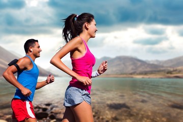 Fitness, sport, friendship and lifestyle concept - smiling couple  running together