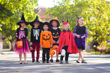 Kids trick or treat. Halloween fun for children.