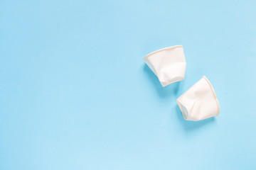 Set of plastic utensils glasses, forks, spoons on a blue background, flat lay. Concept collection of recycling plastic waste recycling. Ecology environmental care