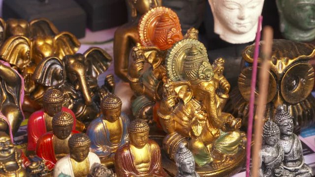 A large collection of gold, painted statuettes of Hindu figures and deities
