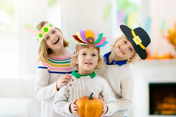 Child on Thanksgiving. Kid with autumn turkey hat.