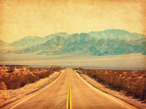 Route 66 crossing the Mojave Desert, California, United States.  Photo in retro style. Added paper texture. Toned image