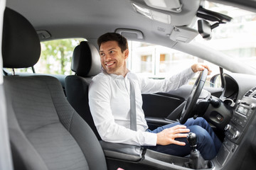 transport, vehicle and driving concept - smiling man or car driver looking back