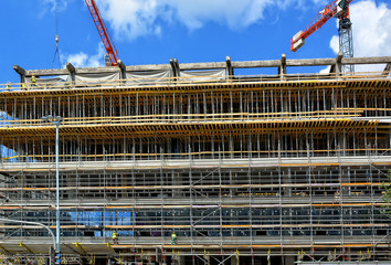 Construction site. Scaffolding. Building frame. Exterior of unfinished building. Modern civil engineering. Construction industry. Close up.