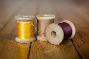 Fototapeta na wymiar antique warm colored spools of thread