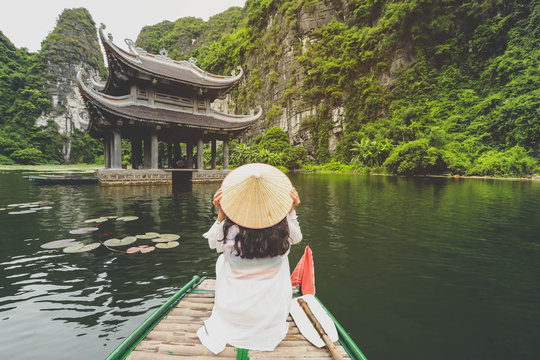 Happy Woman Traveling By Boat Enjoying  The Scenery In Ninh Binh Province, Vietnam