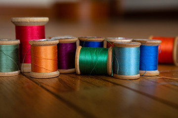 Colorful closeup of vintage wooden spools of thread