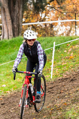 Fototapeta premium female cyclist racing cyclocross