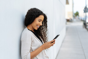 Natural young woman reading an sms on a mobile