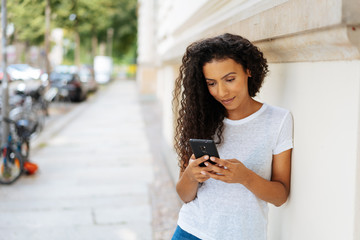 Young woman concentrating on a phone message