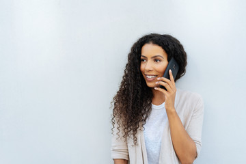 Attractive African woman chatting on her mobile