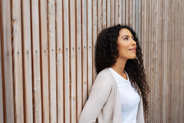 Fototapeta premium Happy young African woman standing daydreaming