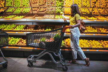 woman at grocery store market with shopping cart