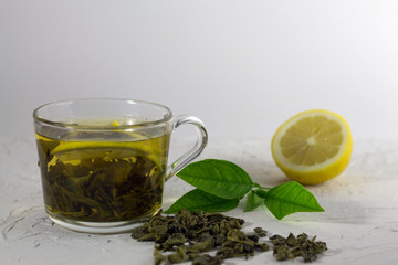 cup of tea with lemon and mint on white background