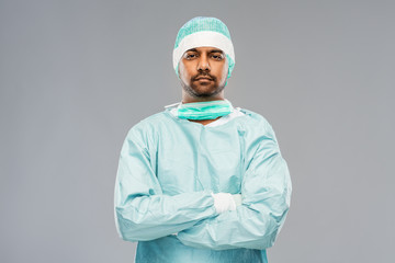 medicine, surgery and people concept - indian male doctor or surgeon in protective wear over grey background