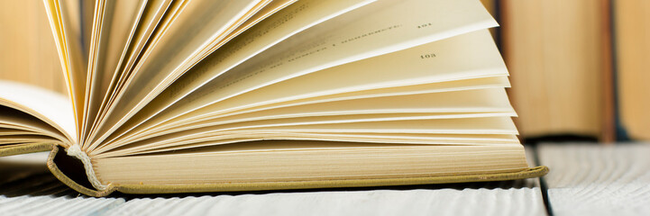 Open book, hardback books on wooden table. Back to school. Copy space