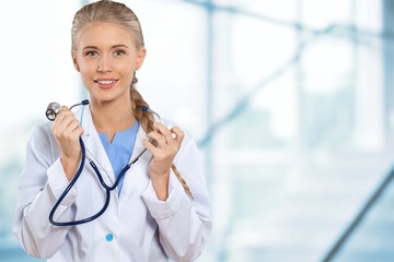 Attractive young female doctor student on background