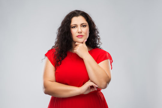 people and choice concept - serious woman in red dress thinking over grey background