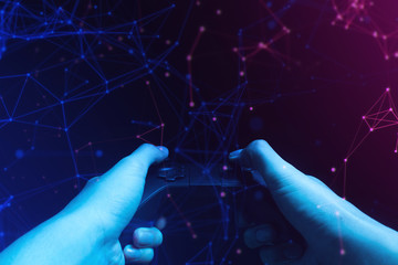 gamer boy with hand holding the joystick controller electronic for playing game with online network connection  technology device in esport tournament challenge concept © issaronow