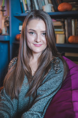 portrait of young smiling woman looking at camera casual clothes