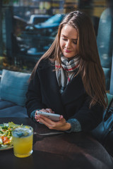 young pretty elegance woman in outdoors cafe using tablet