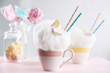 Tasty cotton candy dessert served on table