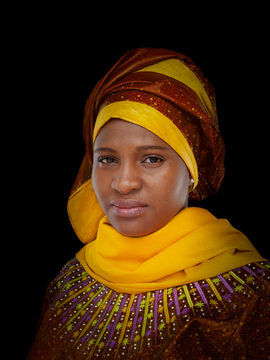 Portrait of a beautiful woman, traditional clothing and headscarf, isolated, black  background 
