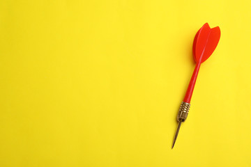Red dart arrow on yellow background, top view with space for text