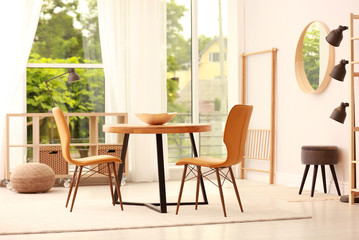 Modern dining room interior with table and chairs