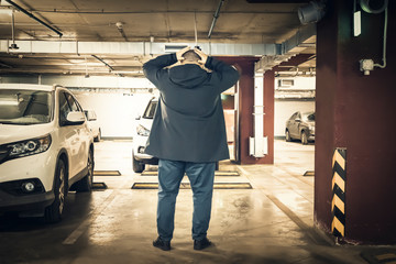 Astonished and surprised man discovered loss of car in underground garage parking lot. Stolen car...
