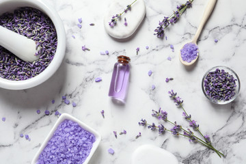 Flat lay composition with lavender flowers and natural cosmetic products on marble background