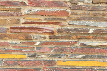 A stone wall of raw stone. Texture of stone. Stone wall.