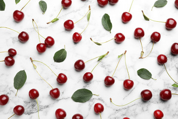 Naklejka na ściany i meble Delicious cherries on marble background, flat lay