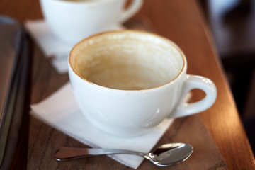 Finished empty cup of coffee in cafe on a wooden table.